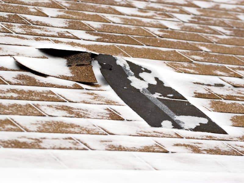 How do snow and ice affect roofing materials